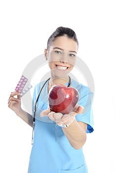 Medical doctor showing apple and pils