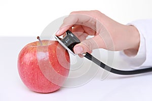 Medical doctor stethoscope examine an apple