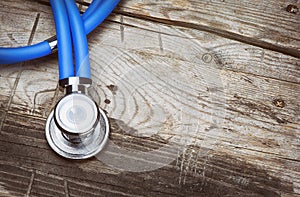 Medical doctor stethoscope on old wood background
