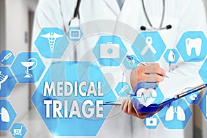 Medical Doctor with stethoscope and MEDICAL TRIAGE sign in Medical network connection on the virtual screen on hospital background photo