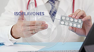 Isoflavones blister pack with tablets in doctor`s hand