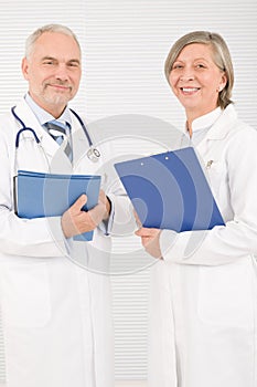 Medical doctor team seniors smiling hold folders