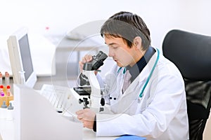 Medical doctor using microscope
