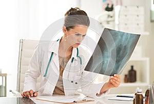 Medical doctor woman with fluorography in office photo