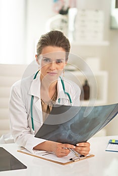 Medical doctor woman with fluorography in office photo