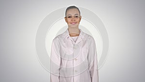Medical doctor woman going straight on gradient background.