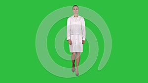 Medical doctor woman going straight on a Green Screen, Chroma Key.