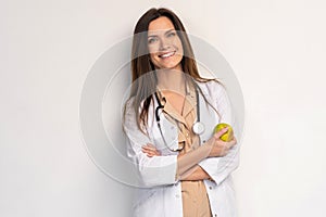 Medical doctor woman smile with stethoscope hold dreen fresh apple in hand. Isolated over white background.