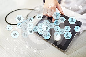 Medical doctor working with modern computer virtual screen interface. Medicine technology and healthcare concept.