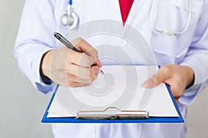 Medical doctor writing prescription on white isolated background Focus on clipboard.