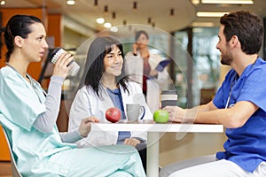 Medical doctors with nurse during lunchbreak