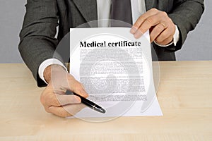 Medical certificate presented by a non-recognizable man photo