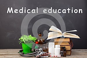 Medical education concept - books, pharmacy bottles, stethoscope