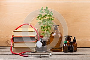 Medical education concept - books, pharmacy bottles and stethoscope