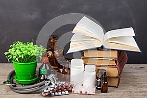 Medical education concept - books, pharmacy bottles, stethoscope