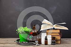 Medical education concept - books, pharmacy bottles, stethoscope in the auditorium with blackboard