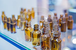 Medical empty glass brown bottles in showcase at pharmaceutical exhibition
