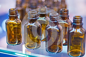 Medical empty glass brown bottles in showcase at pharmaceutical exhibition