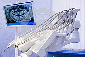 Medical equipment of the dental office. Modern dental clinic. Rhengen image of the oral cavity is displayed on the monitor. Tools