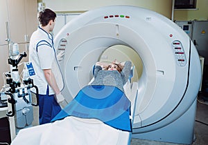 Medical equipment. Doctor and patient in the room of computed tomography