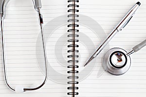 Medical equipments including stethoscope, prescription medicines background, top view flat lay