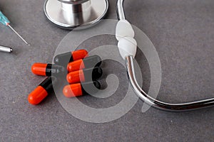 Medical equipments including stethoscope, syringe, drug medicines background, top view flat lay