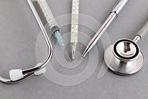 Medical equipments including stethoscope, syringe, medicines background, top view flat lay