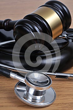 Medical error concept with a stethoscope and a judge gavel close-up