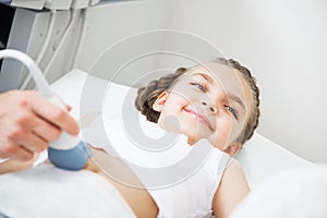 Medical exam little girl by ultrasound equipment