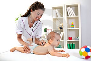 Medical examination while baby lies on the stomach