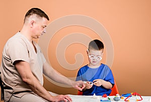 Medical examination. Boy cute child and his father doctor. Hospital worker. First aid. Medical help. Trauma and injurie photo