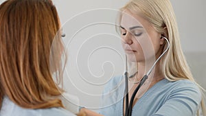 Medical examination: The doctor examines the patient with a stethoscope, providing competent care and professional