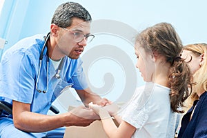 Medical examination of little girl by african doctor