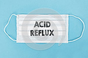 Medical face mask with ACID REFLUX text on blue background