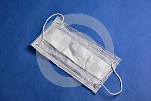 Medical face mask at classic blue background