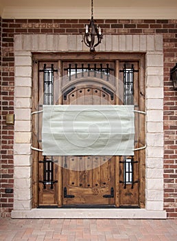 Medical Face Mask Covering Front Door of House.