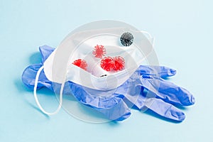 medical face mask, rubber disposable gloves on a blue background