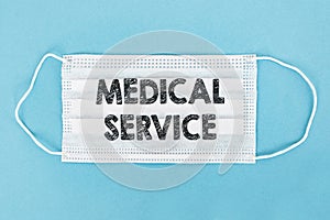 Medical face mask with MEDICAL SERVICE text on blue background