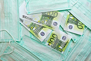 Medical face masks and money. Surgical face mask. COVID-19 has caused a shortage and rise in prices of face masks