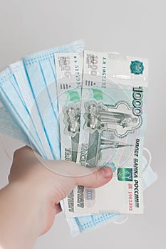 Medical face masks with US dollars and Russian roubles