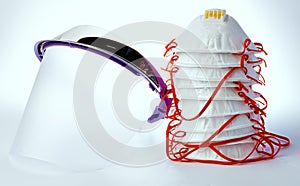 Medical face shield and protective masks on white background