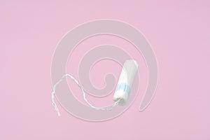 Medical female flyeng tampon on a pink background. Hygienic white tampon for women.Tampons on a pink background