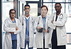 The medical field is amazing. a group of doctors standing in a row together at work.