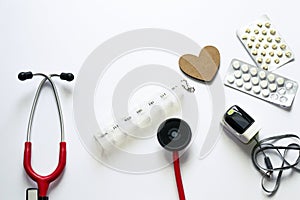 Medical flatlay composition on white background. Treating heart diseases. Prevention of complications. Life support equipment
