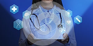 Medical genetics. Female doctor holding tablet computer with DNA helix and other medical icons above screen, collage photo