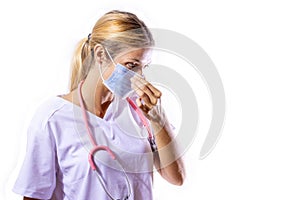 Medical girl adjusting her surgical mask. Health concept. Coronavirus. COVID-19. Pandemic