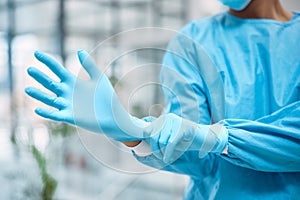 Medical gloves, medical gear and doctor hand in a wellness and health clinic ready for surgery. Safety, research and