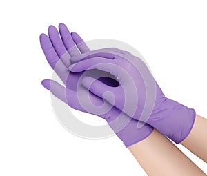 Medical gloves. Two purple surgical gloves isolated on white background with hands. Rubber glove manufacturing, human