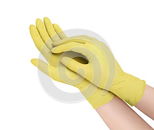 Medical gloves. Two yellow surgical gloves isolated on white background with hands. Rubber glove manufacturing, human