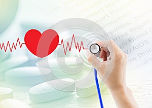 Medical, hand holding stethoscope, heart beat graph and pill